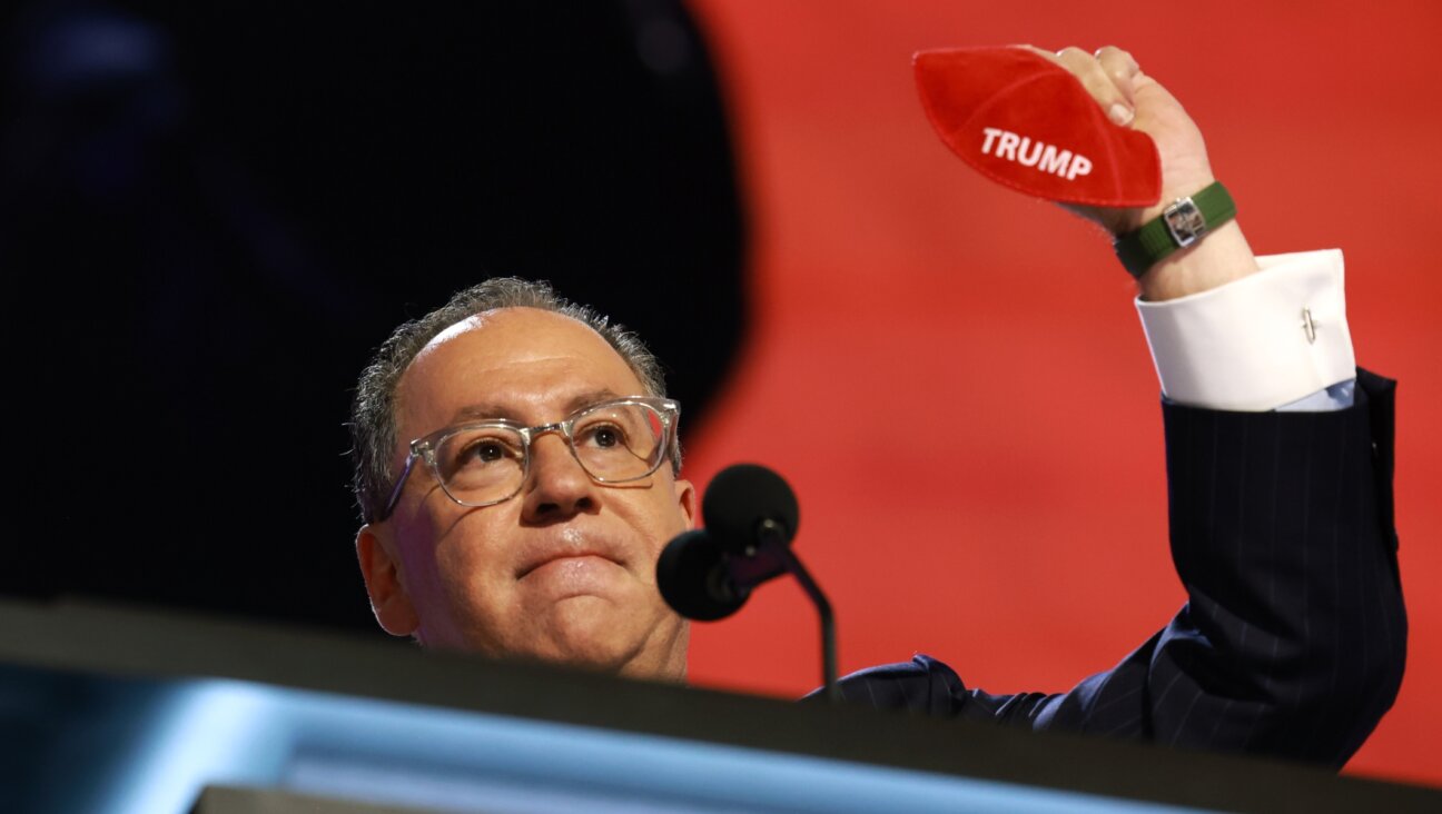 Matt Brooks, CEO of Republican Jewish Coalition holds up a kippah with the name “Trump” on stage on the second day of the Republican National Convention at the Fiserv Forum, Milwaukee, July 16, 2024. (Joe Raedle/Getty Images)