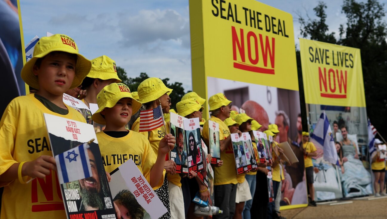 People hold pictures of Israeli hostages during a vigil on the National Mall, July 23, 2024. (Justin Sullivan/Getty Images)