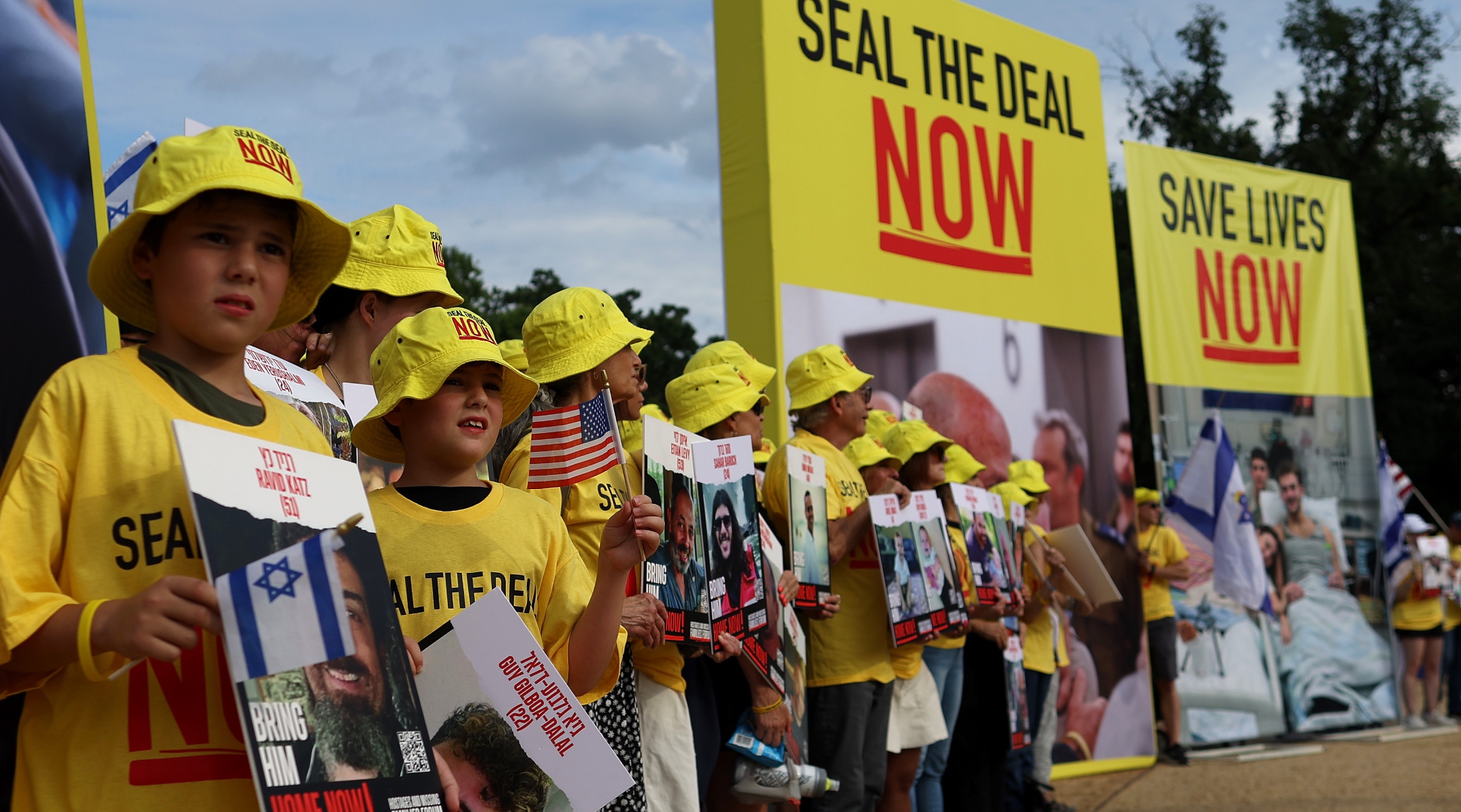 People hold pictures of Israeli hostages during a vigil on the National Mall, July 23, 2024. (Justin Sullivan/Getty Images)