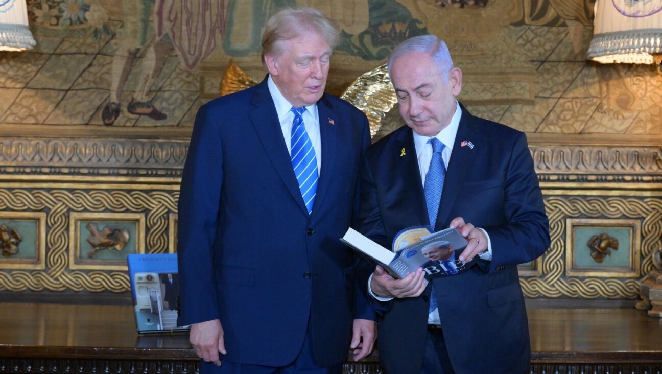 Israeli Prime Minister Benjamin Netanyahu shares with former President Donald Trump his autobiography at Trump’s estate, Mar-a-Lago, Palm Beach, Florida, July 26, 2024. (Amos Ben-Gershom, Israel Government Press Office)