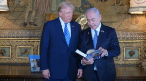 Israeli Prime Minister Benjamin Netanyahu shares with former President Donald Trump his autobiography at Trump’s estate, Mar-a-Lago, Palm Beach, Florida, July 26, 2024. (Amos Ben-Gershom, Israel Government Press Office)