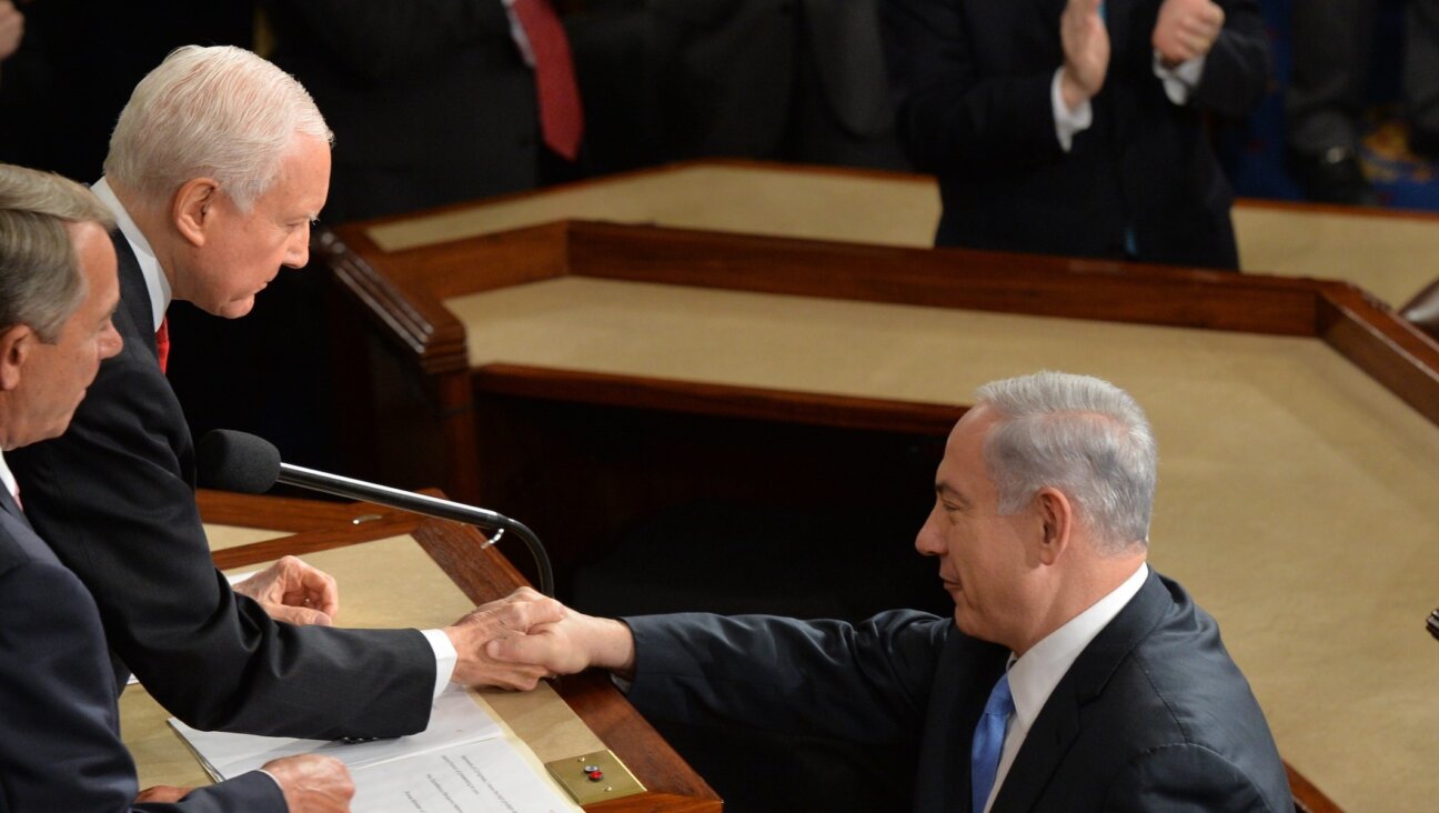 Israeli Prime Minister Benjamin Netanyahu shakes hands with Sen. Orrin Hatch (R-Utah) and Speaker of the House John Boehner (R-Ohio) before he addresses a joint meeting of the U.S. Congress at the Capitol in Washington, March 3, 2015. (Nicholas Kamm/AFP via Getty Images)