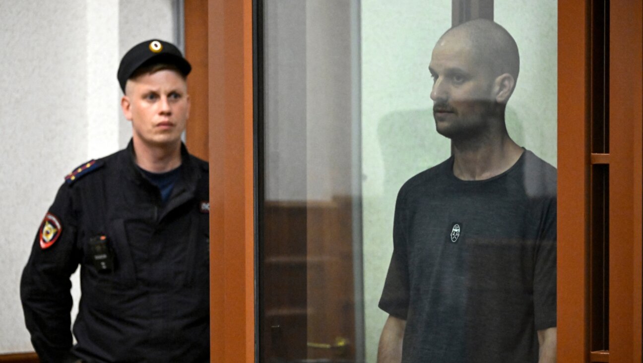 American journalist Evan Gershkovich stands in a glass defendant’s cage during the verdict announcement at the Sverdlovsk Regional Court in Yekaterinburg on July 19, 2024. (Alexander Nemenov/AFP via Getty Images)