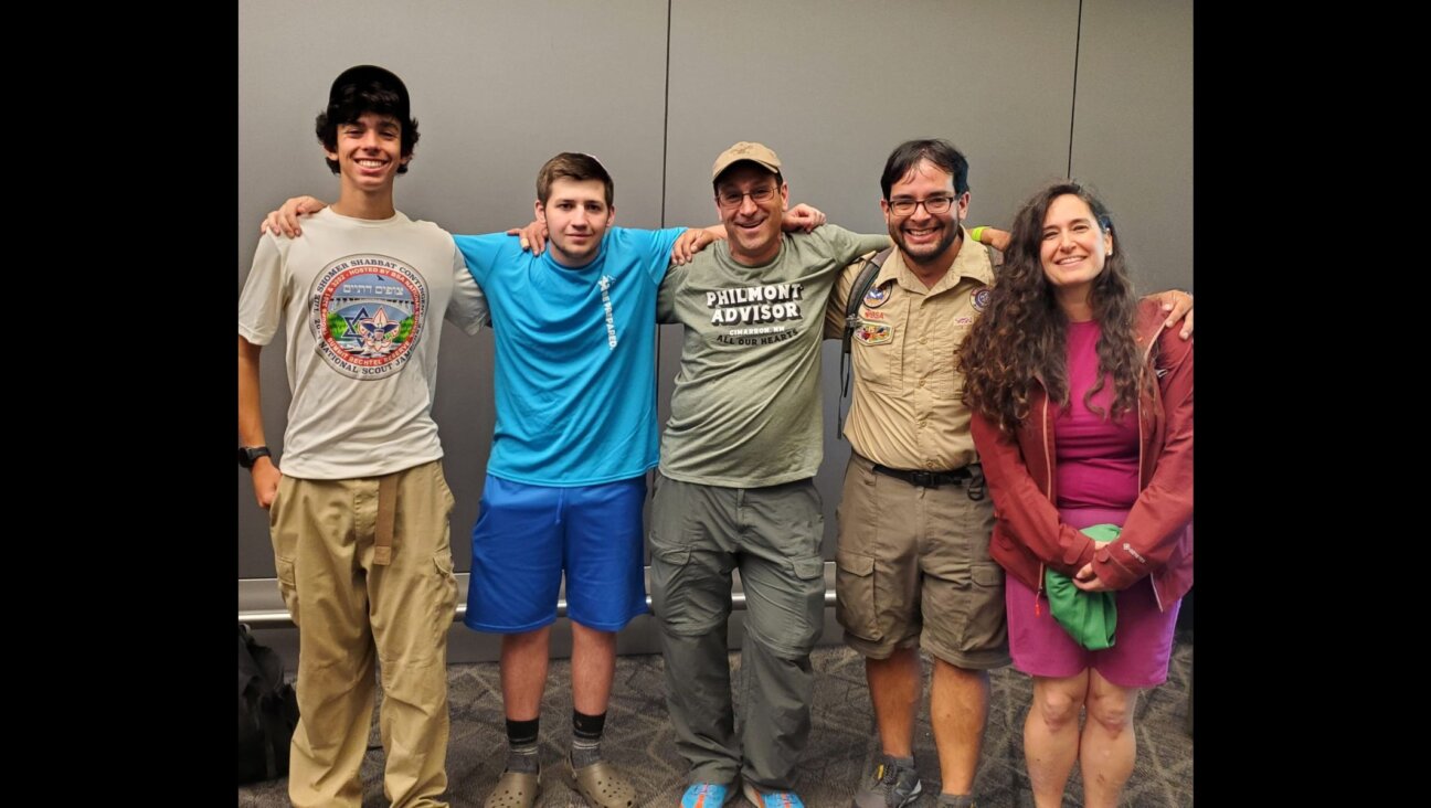 Ariel Yaron (left), Moshe Grimaldi (second from left), Evan Gilder (center) were among five members of a Jewish contingent of Boy Scouts who participated in a CPR rescue aboard a flight to New York on July 11, 2024. (Courtesy Evan Gilder)