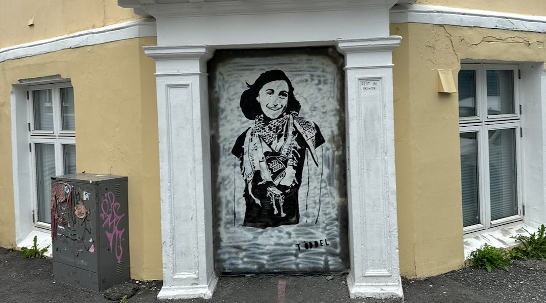 A mural of Anne Frank wearing a keffiyeh in Bergen, Norway, painted by the anonymous artist Töddel, July 2024. (Courtesy of Töddel)