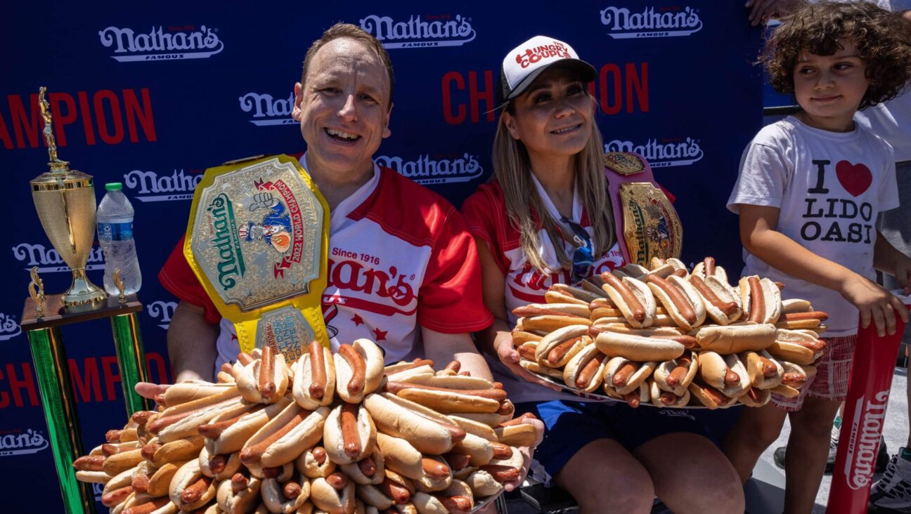 Joey Chestnut (L) and Miki Sudo (R) hold 63 and 40 hot dogs respectively after winning the Nathan's Famous 4th of July 2022 hot dog eating contest on Coney Island on July 4, 2022 in New York. (Photo by Yuki IWAMURA / AFP) (Photo by YUKI IWAMURA/AFP via Getty Images)