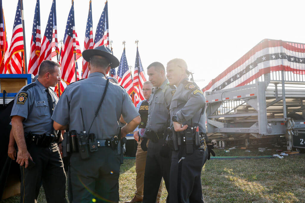 Law enforcement agents stand near the stage of a campaign rally after an assassination attempt on former President Donald Trump.