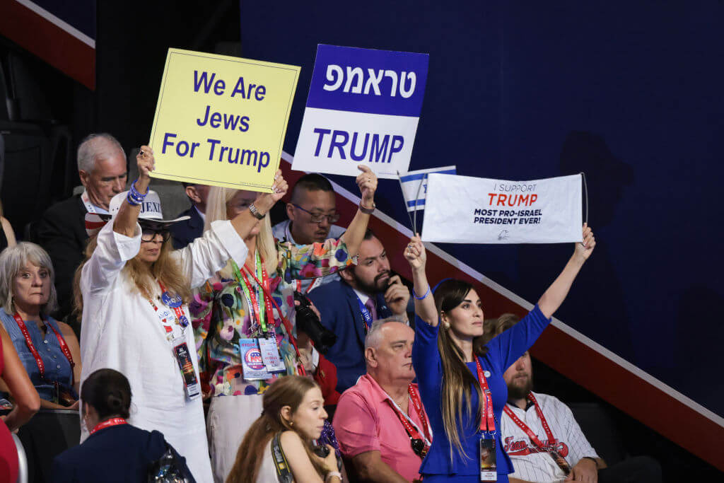 People hold signs that say "We are Jews For Trump" at the Republican National Convention.