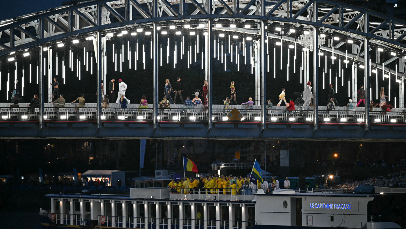 Models walking a catwalk erected along Seine during the opening ceremony.