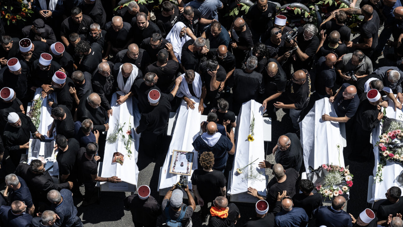 Thousands attend the funeral ceremony for children and teens killed in a rocket attack in Majdal Shams, Israel, on July 28, 2024. (Mostafa Alkharouf/Anadolu via Getty Images)