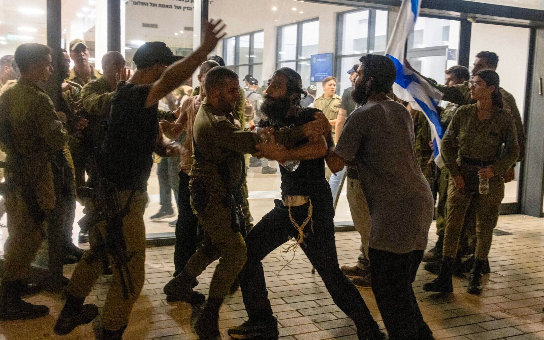 Israeli soldiers and police clash with right-wing protesters after they broke into the Beit Lid army base over the detention for questioning of military reservists who are suspected of abuse of a detainee, July 29, 2024. (Oren Ziv/AFP via Getty Images)