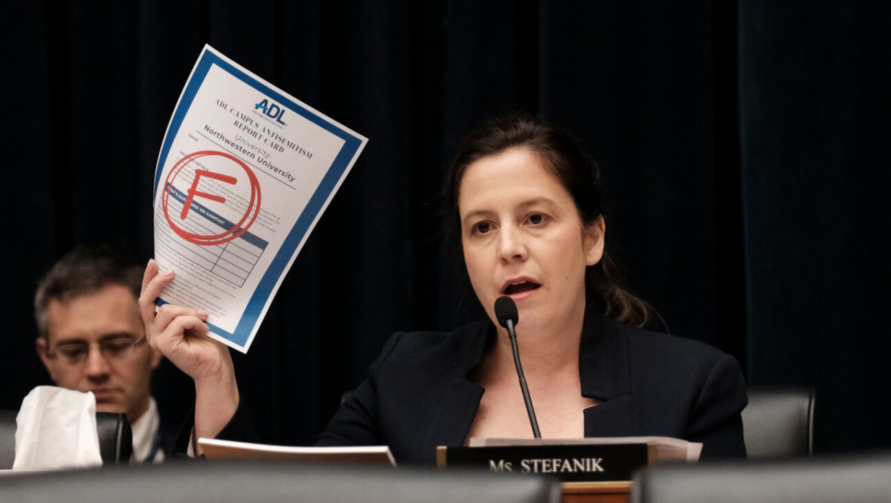 Rep. Elise Stefanik (R-N.Y.) displays the Anti-Defamation League's report card for Northwestern as the presidents of that school, Rutgers and UCLA testify at a hearing called "Calling for Accountability: Stopping Antisemitic College Chaos" before the House Committee on Education and the Workforce May 23.