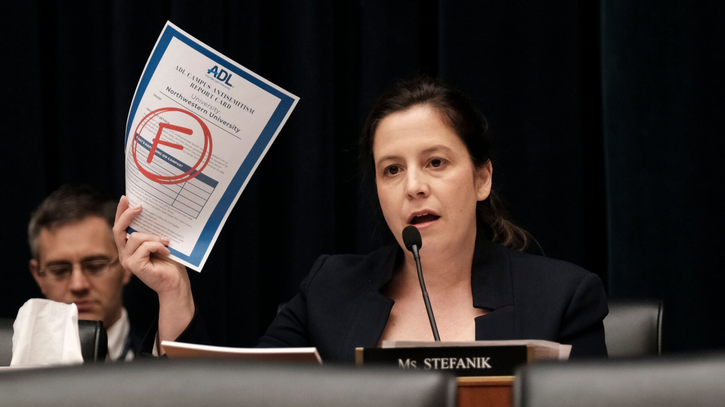 Rep. Elise Stefanik (R-N.Y.) displays the Anti-Defamation League's report card for Northwestern as the presidents of that school, Rutgers and UCLA testify at a hearing called "Calling for Accountability: Stopping Antisemitic College Chaos" before the House Committee on Education and the Workforce May 23.