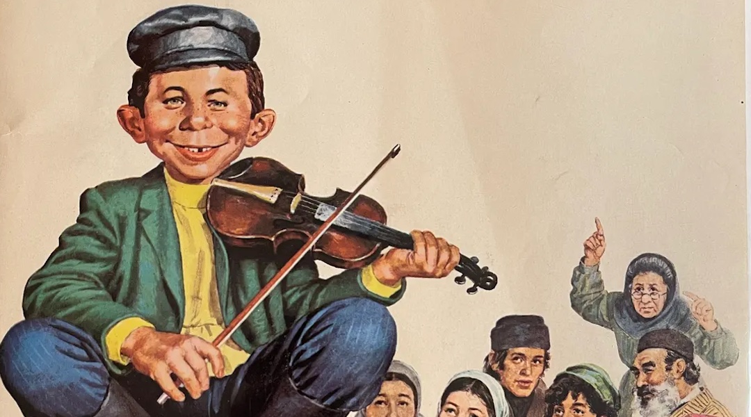 “What, Me Worry? The Art and Humor of MAD Magazine,” an exhibit at the Norman Rockwell Museum, features Norman Mingo’s 1973 cover illustration for MAD Magazine #156 depicting Alfred E. Neuman as a character in “Fiddler on the Roof.” (JTA Photo; MAD and all related elements © & ™ E.C. Publications. Courtesy of DC. All Rights Reserved. Used with permission.)