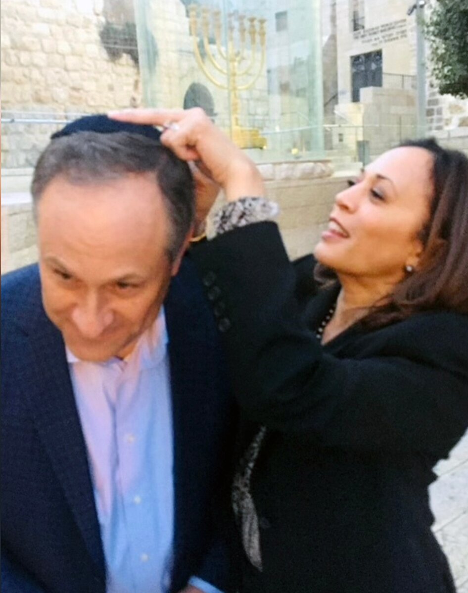 Kamala Harris affixes a kippah to the head of her husband, Doug Emhoff, as they visit the Western Wall, Jerusalem, November 2017. 