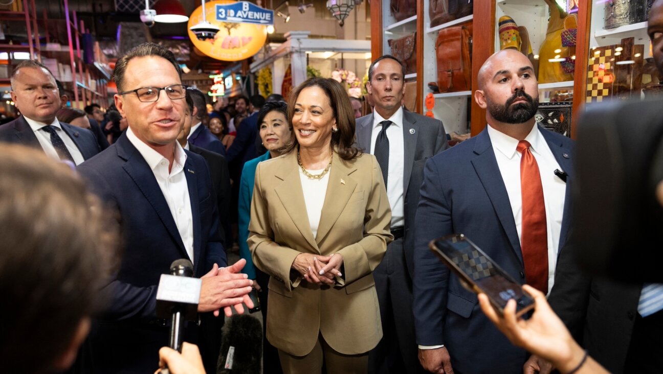 Vice President Kamala Harris and Pennsylvania Gov. Josh Shapiro, left, speak to the press while making a stop at the Reading Terminal Market in Philadelphia, Pennsylvania, July 13, 2024. (Ryan Collerd / AFP via Getty Images)