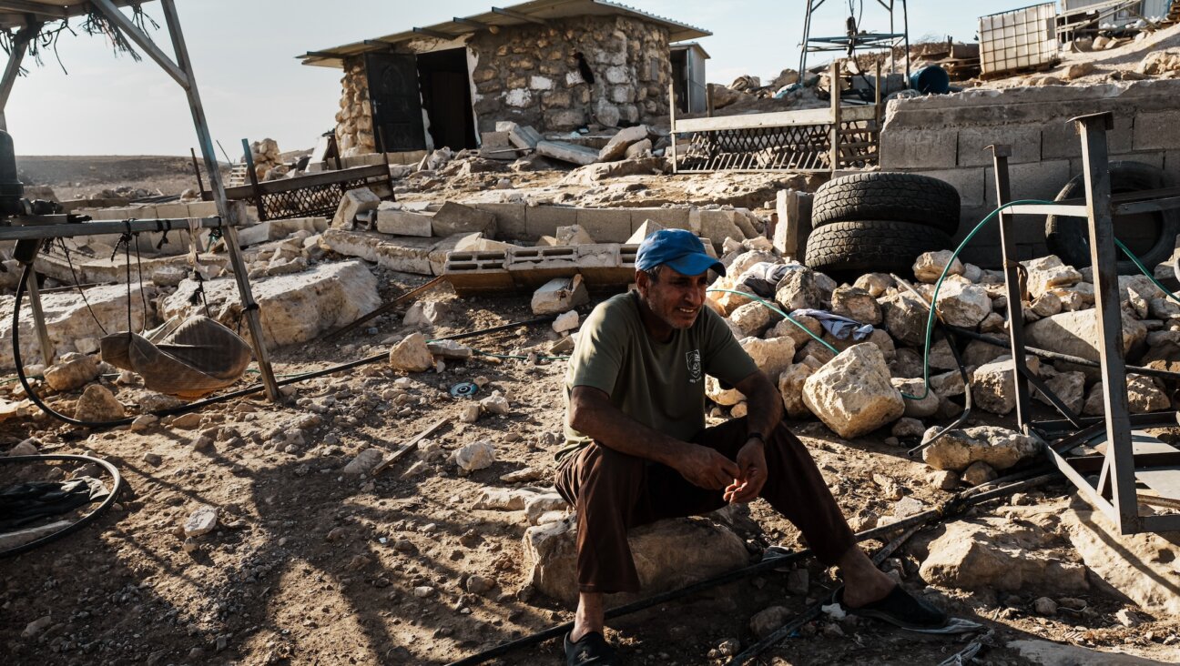 Hamad Melhem al Hudarat reacts as he watches other Palestinian families pack up their belongings, dismantle their homes and uproot their lives along with other Palestinians after a decision was made as a community to leave due to repeated reports of Israeli settler violence and harassment, in the village of Khirbet Zanuta, in the West Bank, Oct. 30, 2023. (Marcus Yam/ Los Angeles Times)