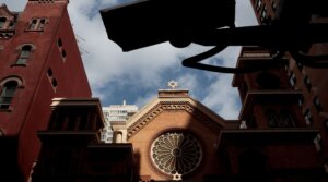 A security camera hangs across the street from the Park East Synagogue, in New York City. Jewish institutions are tightening security amid rising threats. 