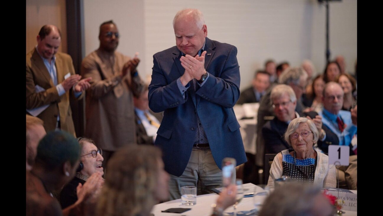 Holocaust survivor and education activist Dora Zaidenweber, (seated left) is given a standing ovation by Minnesota Gov. and Democratic vice presidential nominee Tim Walz (center) in June 2023. (Darrell Owens Photography)