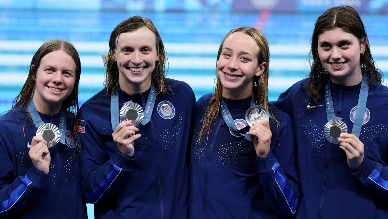 L-R: Erin Gemmel, Katie Ledecky, Paige Madden and Claire Weinstein after winning silver in the women’s 4×200-meter freestyle relay at the 2024 Paris Olympics, Aug. 1, 2024, in Nanterre, France. (Clive Rose/Getty Images)