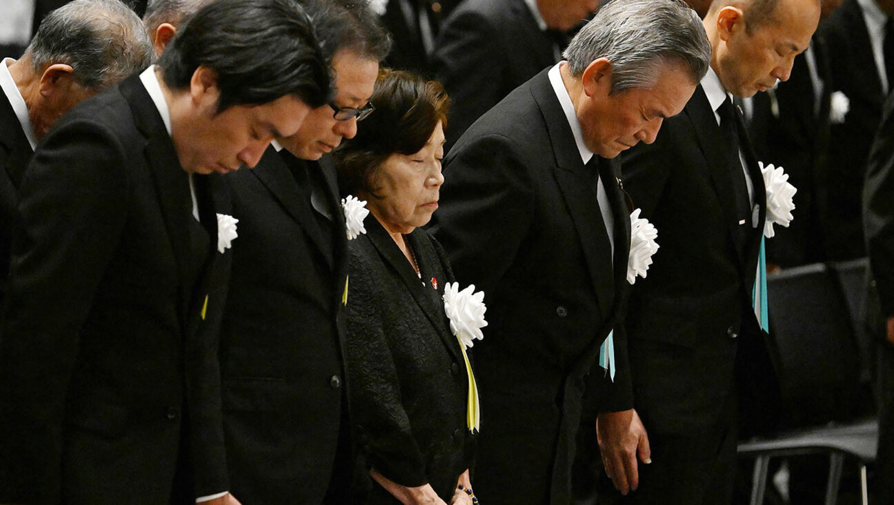 Eighty-five-year-old atomic bombing survivor Takeko Kudo (3rd L) and other representatives observe a moment of silence at the time of the bombing at 11:02am during a peace memorial ceremony in Nagasaki.