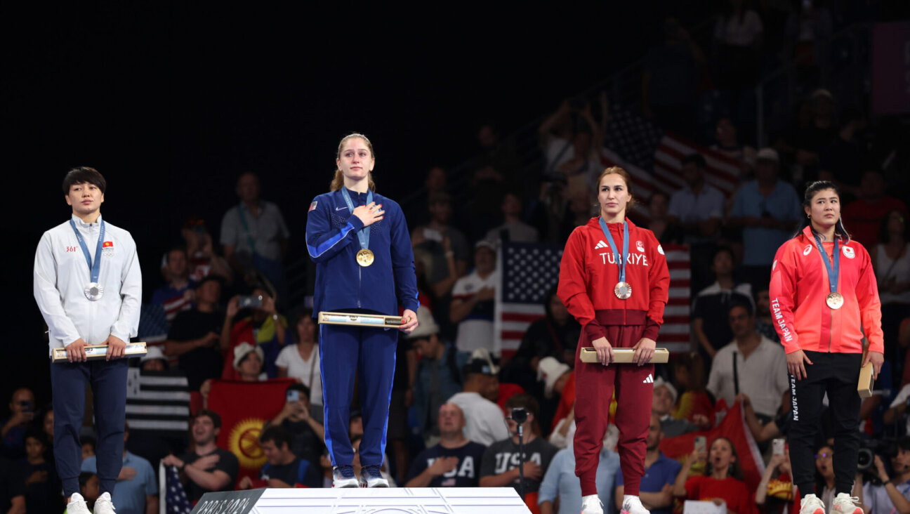 Gold medalist Amit Elor stands on the podium during the wrestling women’s freestyle 68kg medal ceremony of the Paris Olympic Games, Aug. 6, 2024. (Sarah Stier/Getty Images)