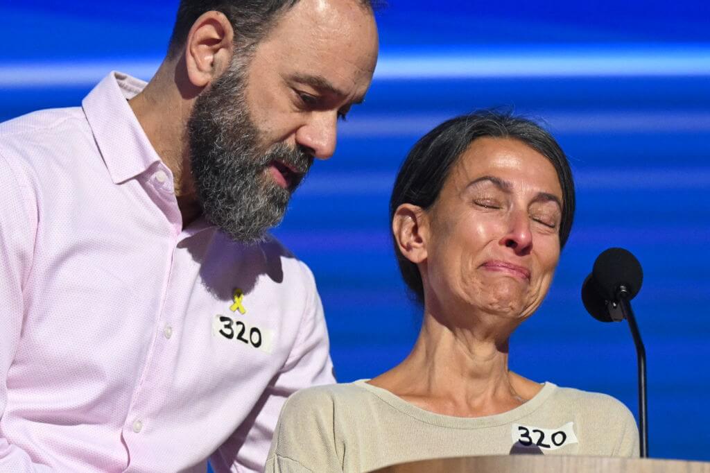 Jon Polin comforts his wife Rachel Goldberg as she speaks about their son Hersh Goldberg Polin, who is being held hostage by Hamas, on the third day of the Democratic National Convention in Chicago on August 21, 2024.