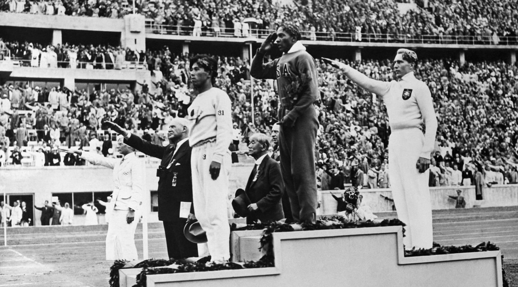 L-R: Bronze medalist Naoto Tajima of Japan, gold medalist Jesse Owens of the U.S. and silver medalist Luz Long of Germany on the podium for the long jump competition at the Berlin Olympics, Aug. 8, 1936. (Bettman/Getty)