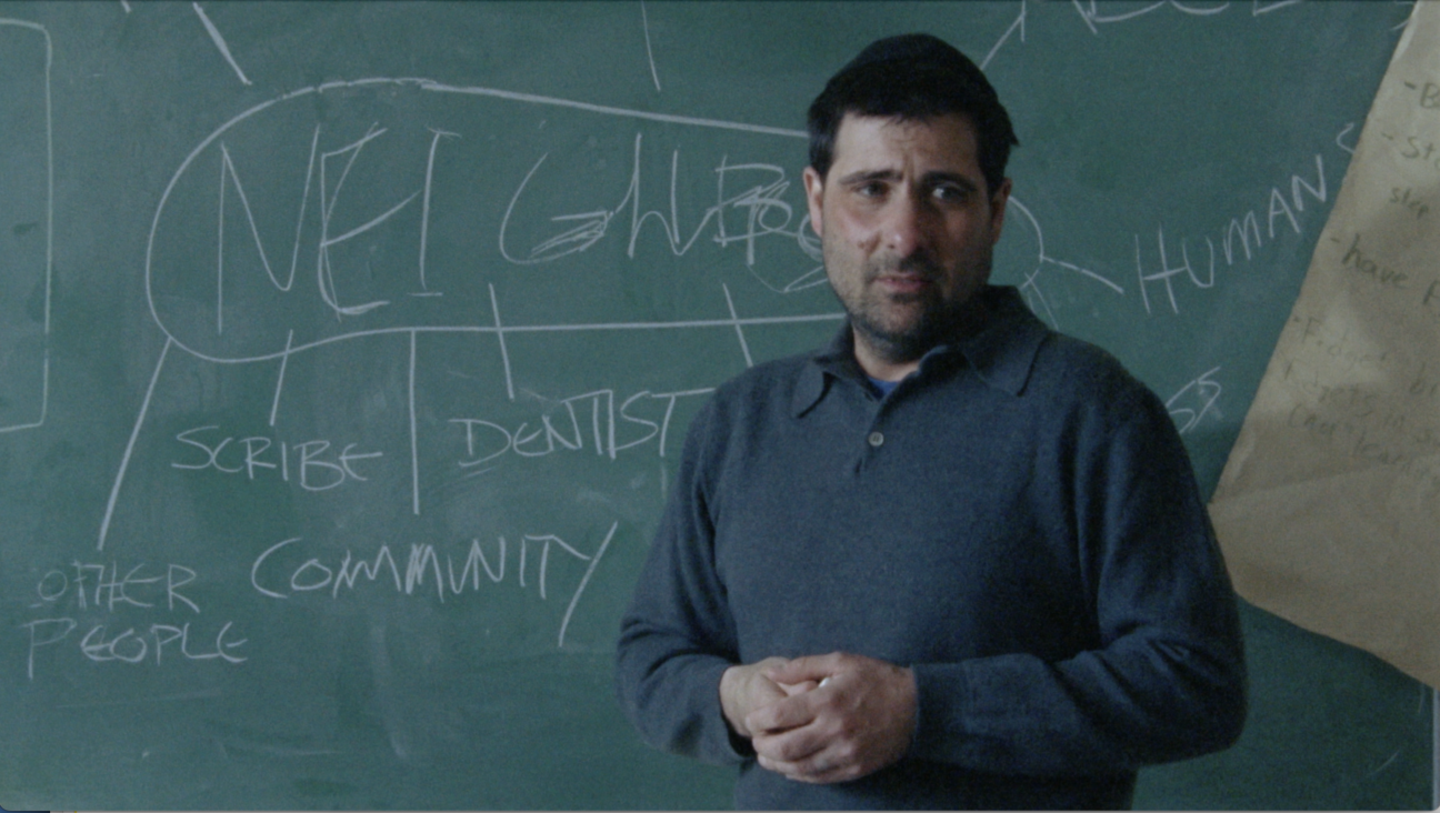 Jason Schwartzman, teaching a group of young Jews about what it means to love one's neighbor in <i>Between the Temples</i>.