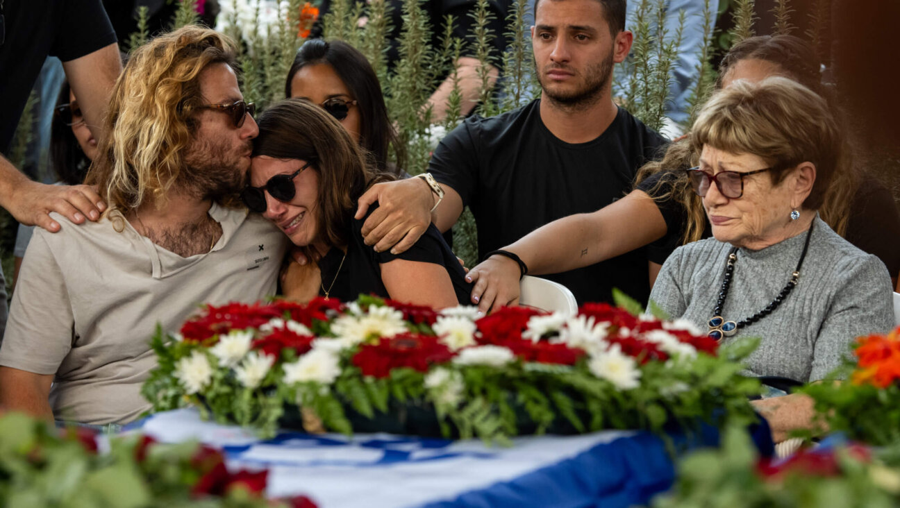 RUHAMA, Israel -  Raz and Tomer Itamari embrace and cry during the Oct. 29 funeral of their parents, Lili Itamari, 63, and Ram Itamari, 56, who were killed during Hamas' Oct. 7 terror attack on Israel. 