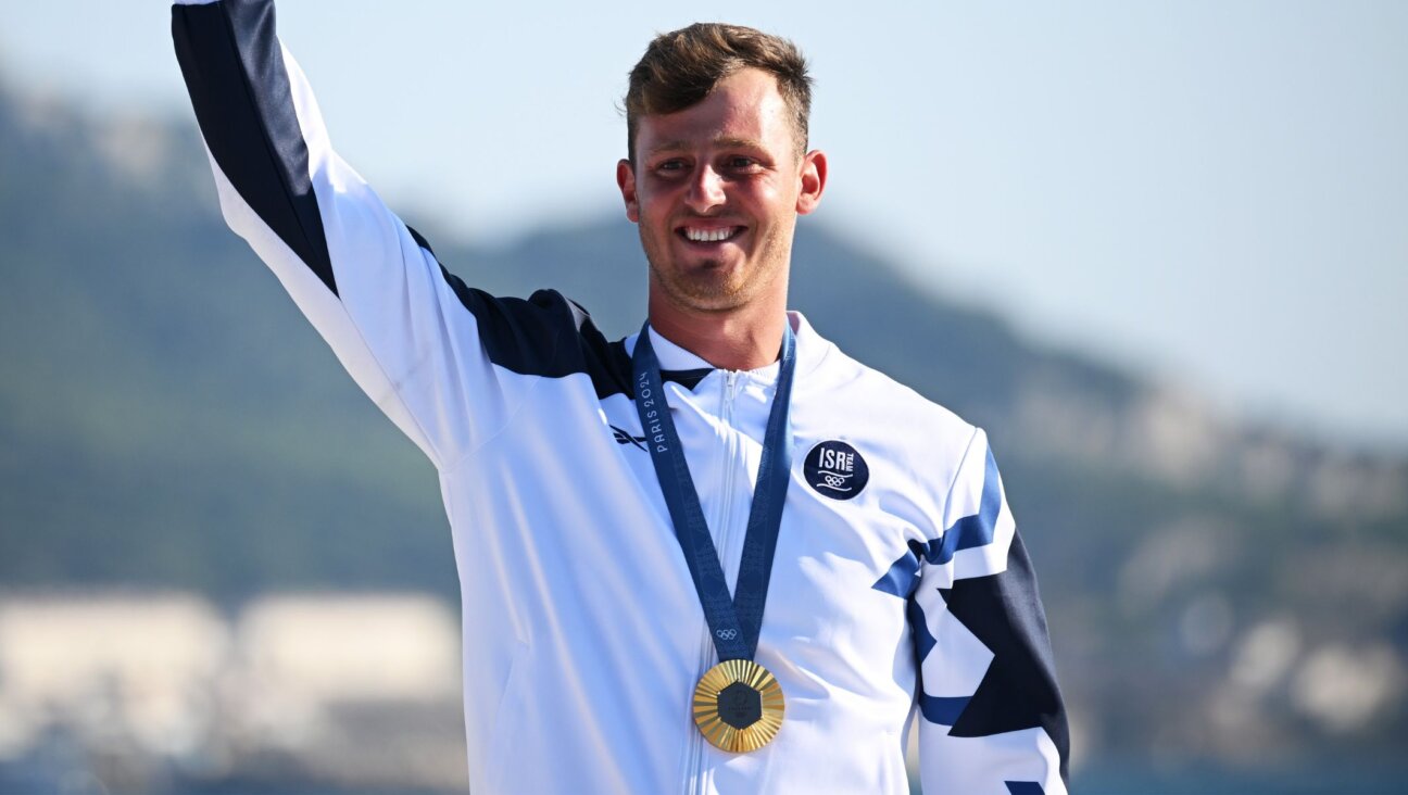 Tom Reuveny celebrates after winning the gold medal in the men’s windsurfing iQFoil final at the 2024 Paris Olympics, Aug. 3, 2024, in Marseille, France. (Clive Mason/Getty Images)