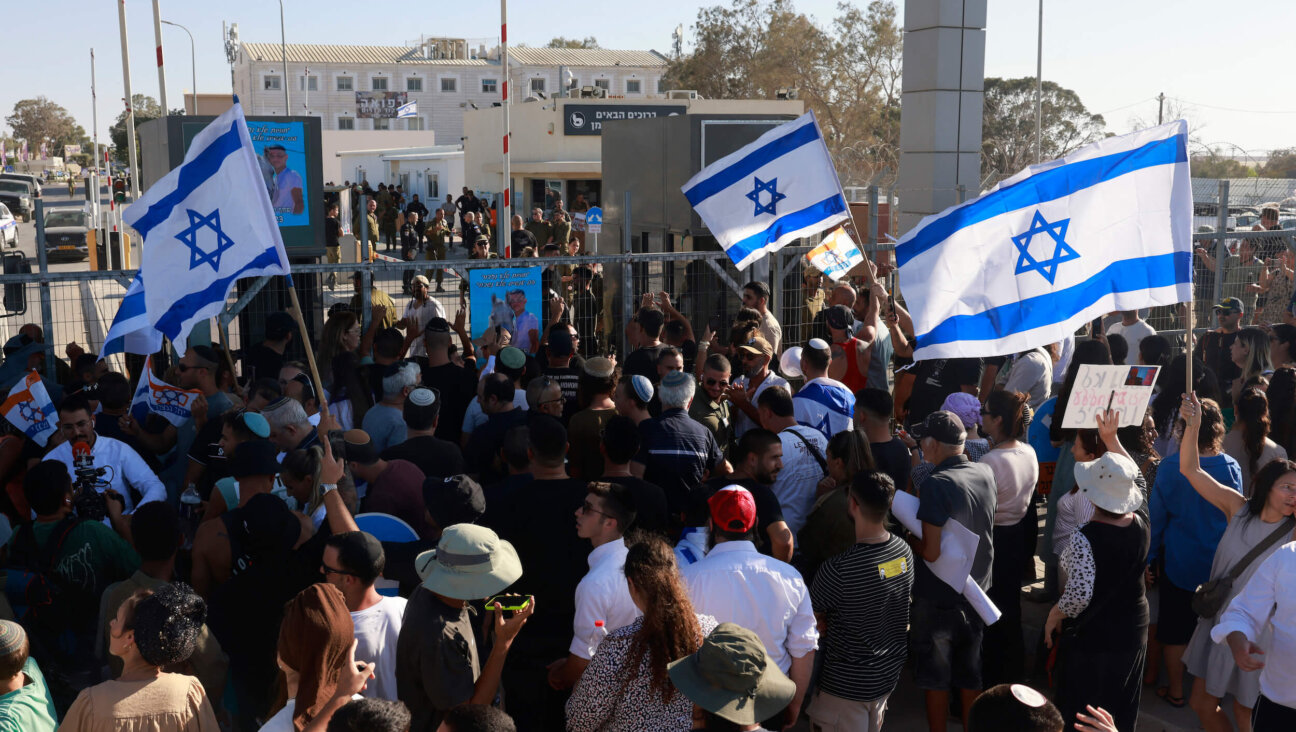 Right-wing Israelis demonstrate outside the Sde Teiman military base near Beersheba on Monday. 
