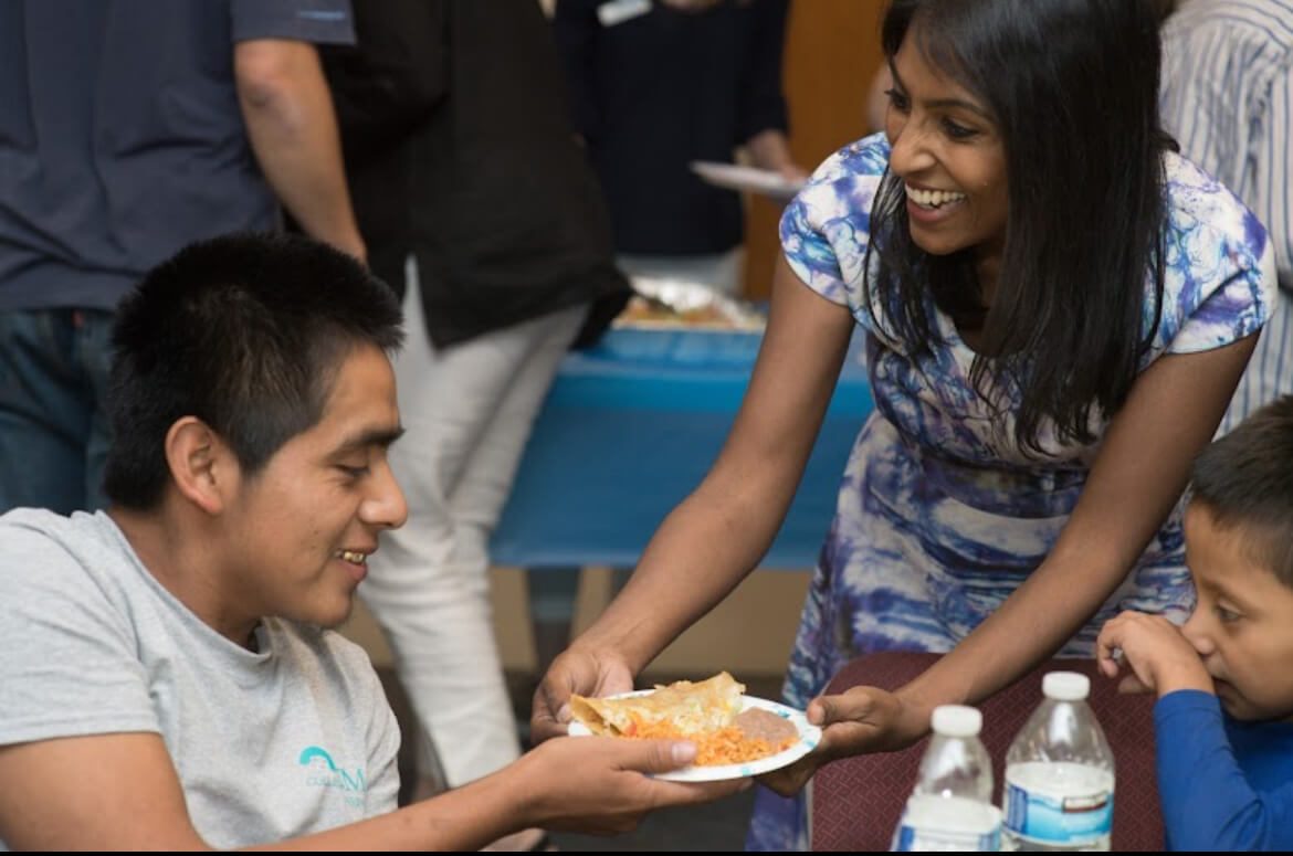 Global Refuge President and CEO, Krish O’Mara Vignarajah, offers a hot meal to an asylum seeking family at one of the nonprofit’s respite centers near Albuquerque, New Mexico.