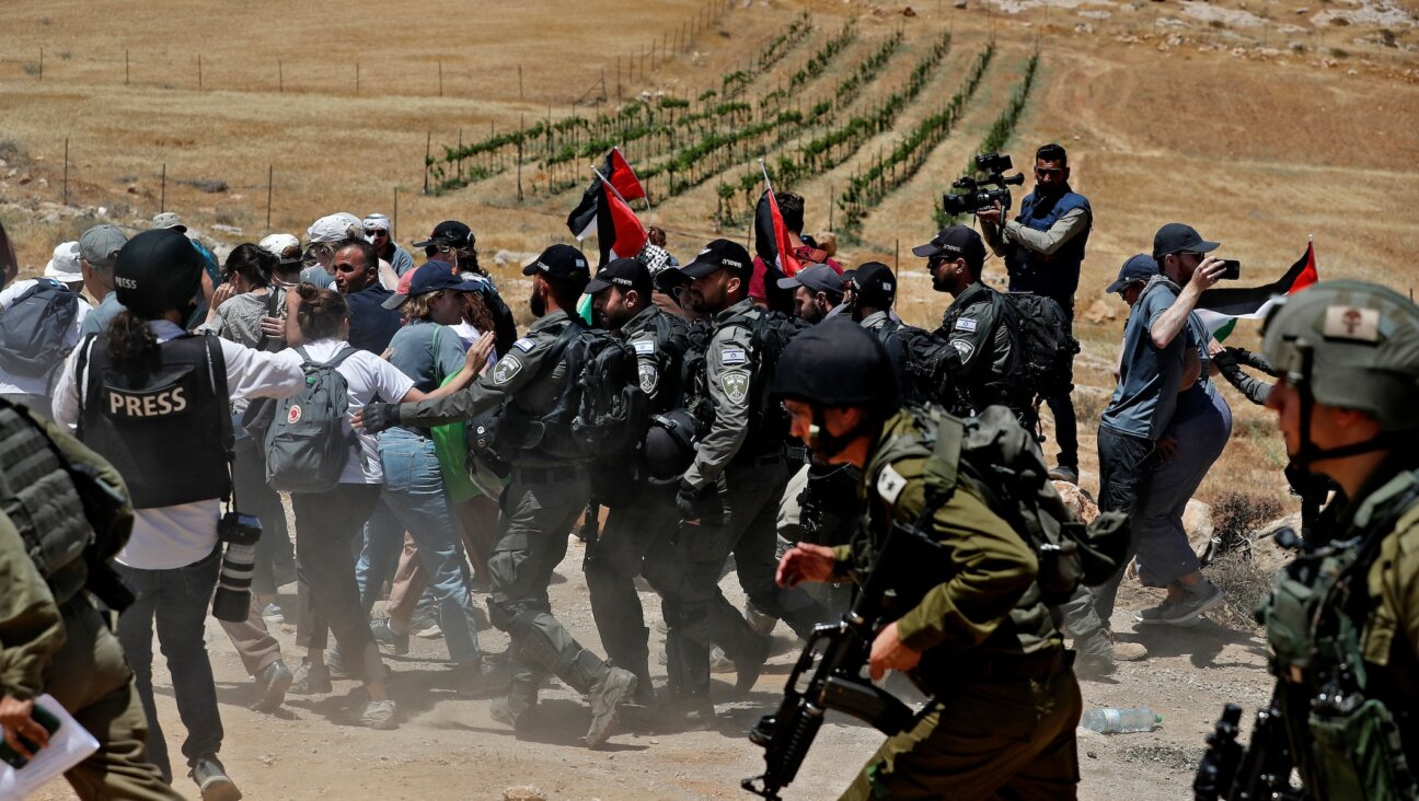 Israeli security forces try to disperse Palestinian, left-wing Israeli and foreign activists, during a protest near the West Bank Israeli settlement of Mitzpe Yair in Masafer Yatta near Hebron on June 10, 2022. (Ahmad Gharabli/AFP via Getty Images)