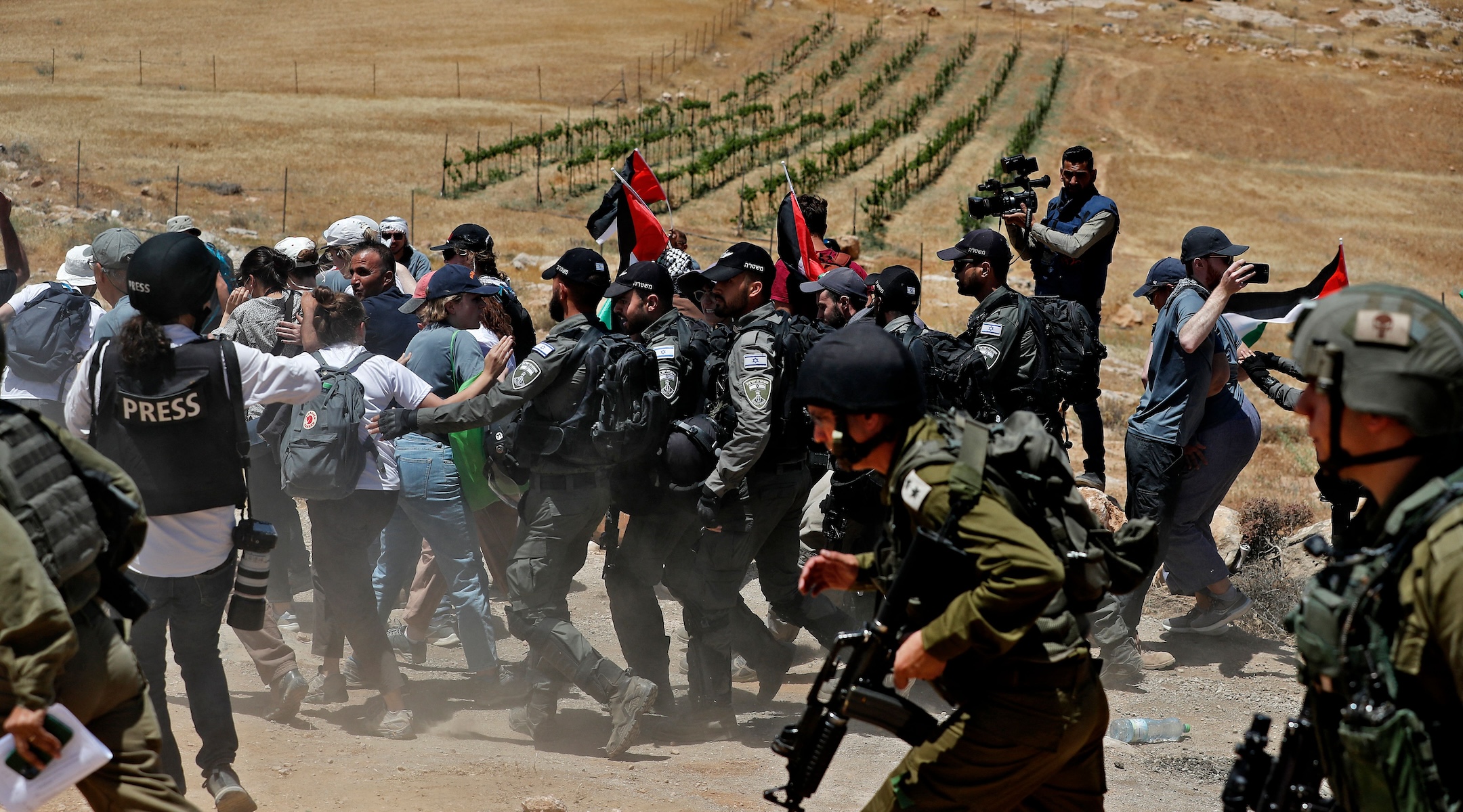 Israeli security forces try to disperse Palestinian, left-wing Israeli and foreign activists, during a protest near the West Bank Israeli settlement of Mitzpe Yair in Masafer Yatta near Hebron on June 10, 2022. (Ahmad Gharabli/AFP via Getty Images)