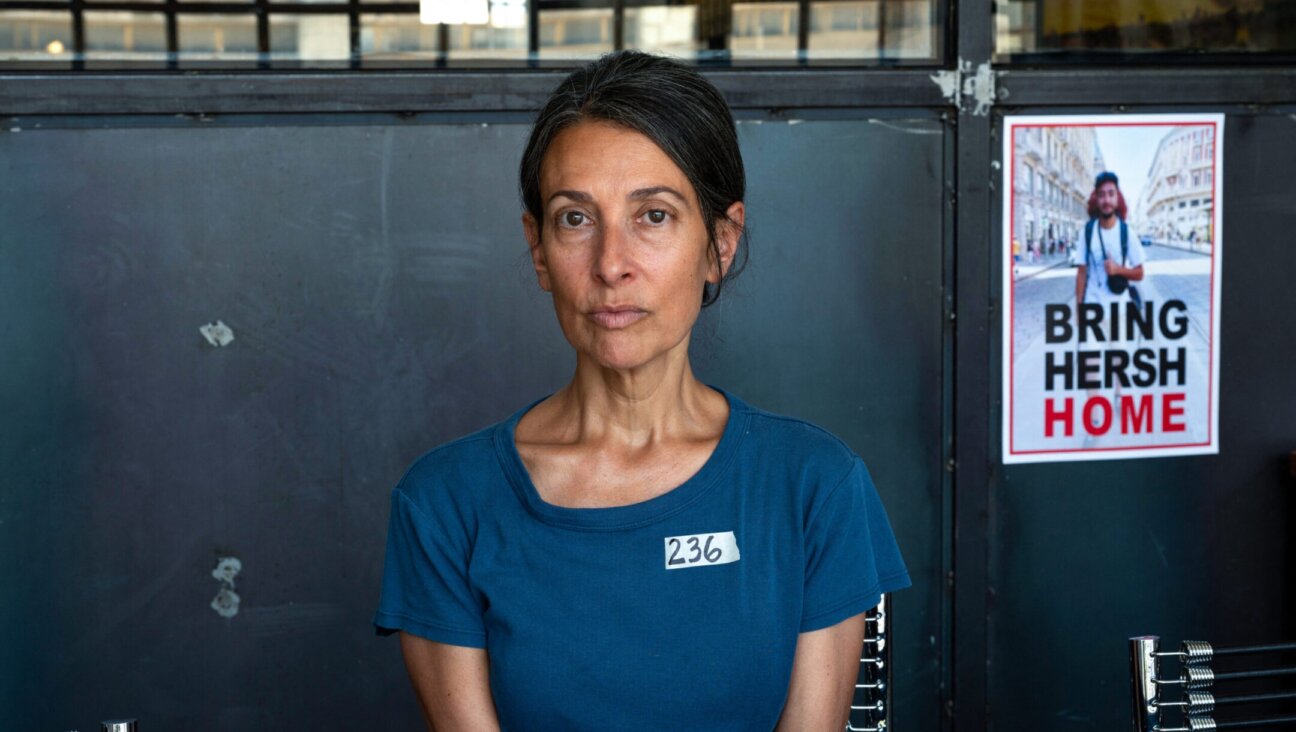 Rachel Goldberg-Polin, the mother of Hersh Goldberg-Polin, who was taken hostage by Hamas on Oct. 7, poses for a photo next to a poster of her son during an interview in Jerusalem, May 29, 2024. (Ahikam Seri/AFP via Getty Images)