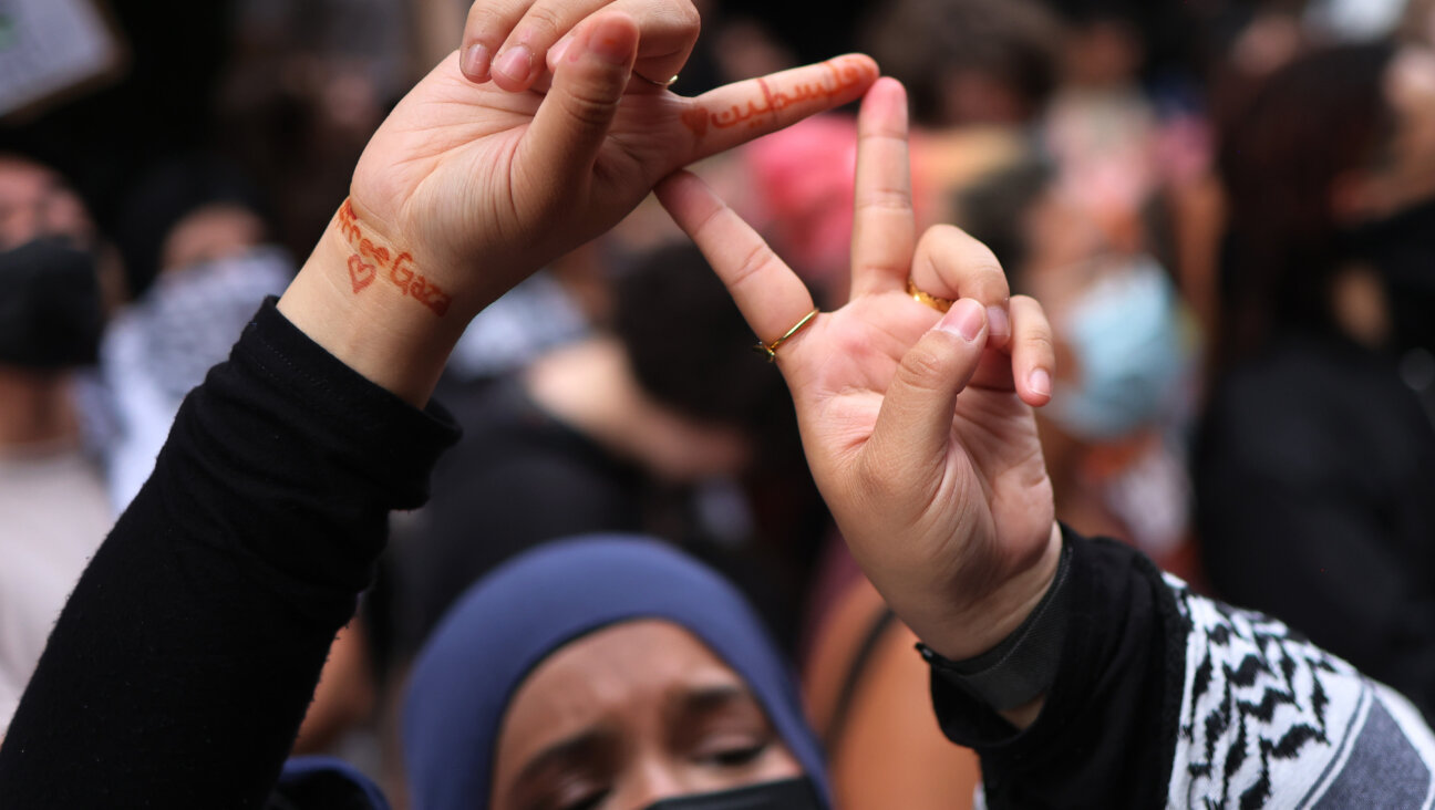 A protester demonstrating against Baruch Hillel in June flashes a symbol associated with Hamas.