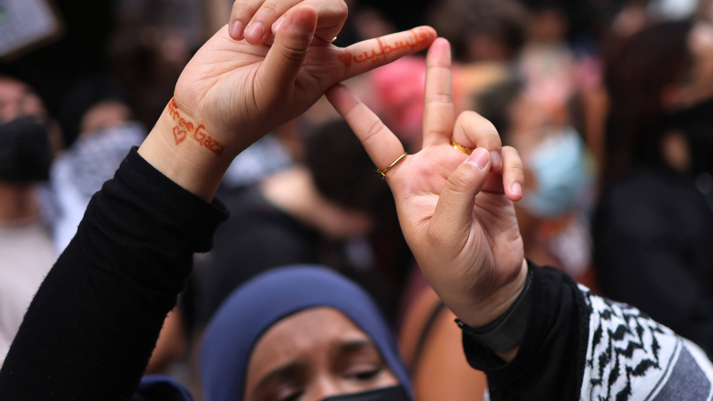 A protester demonstrating against Baruch Hillel in June flashes a symbol associated with Hamas.