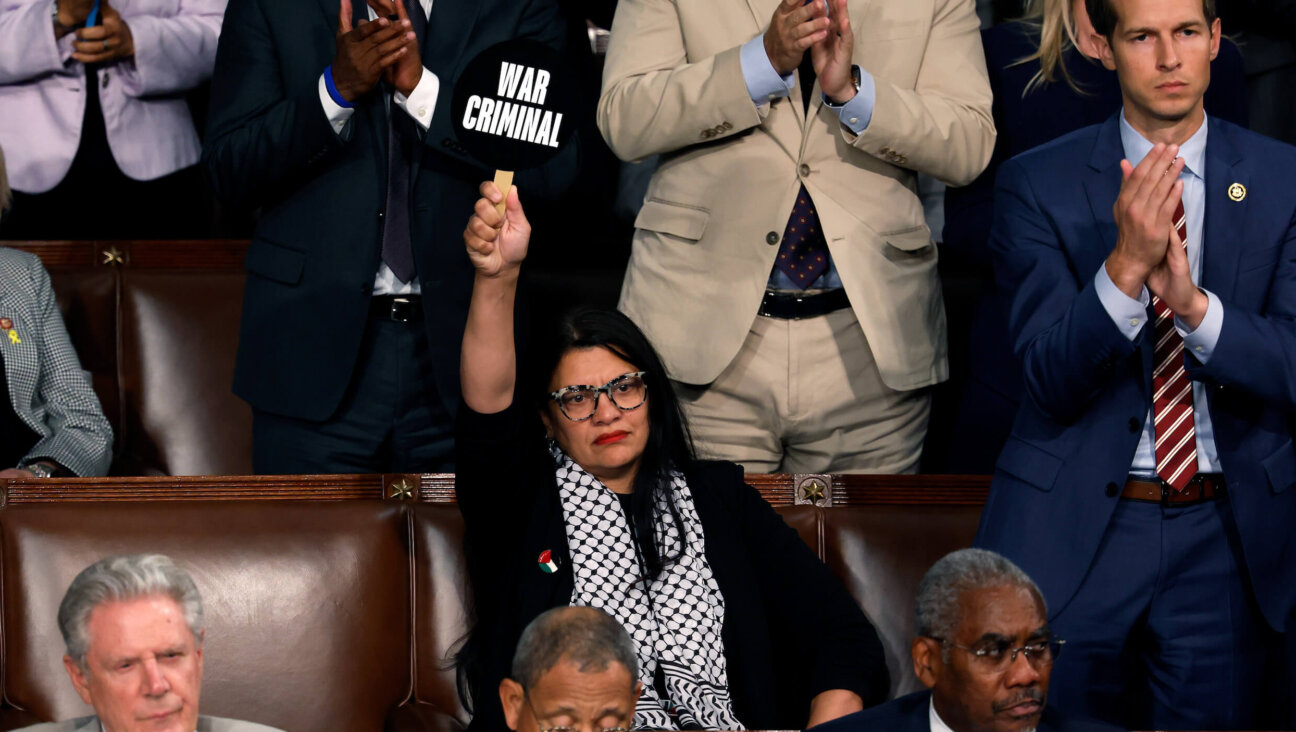 Rep. Rashida Tlaib holds a sign that reads "War Criminal" as Israeli Prime Minister Benjamin Netanyahu speaks on July 24 in Washington, D.C.  