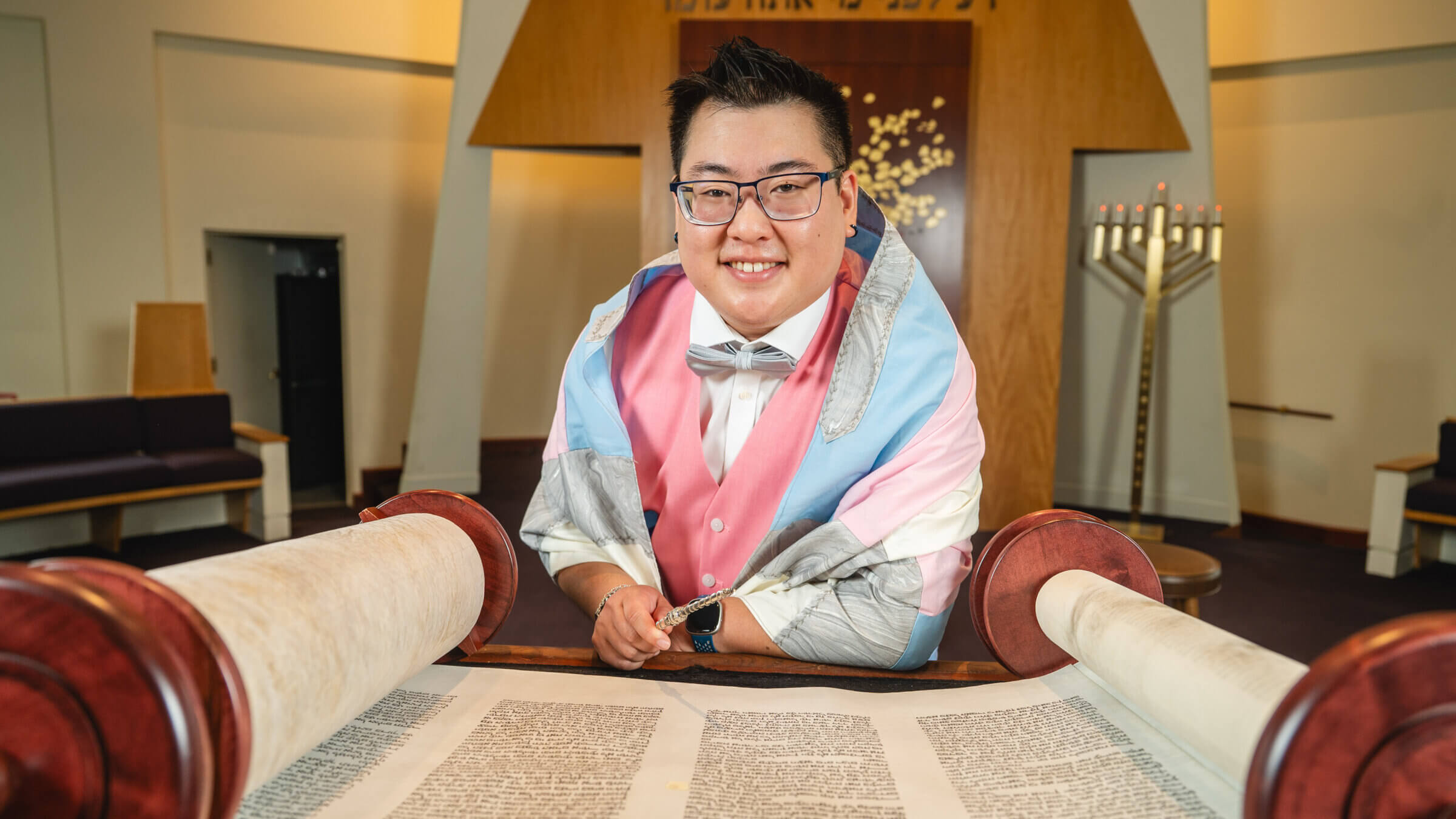 Emet Marwell, wearing a prayer shawl in the colors of the transgender flag.