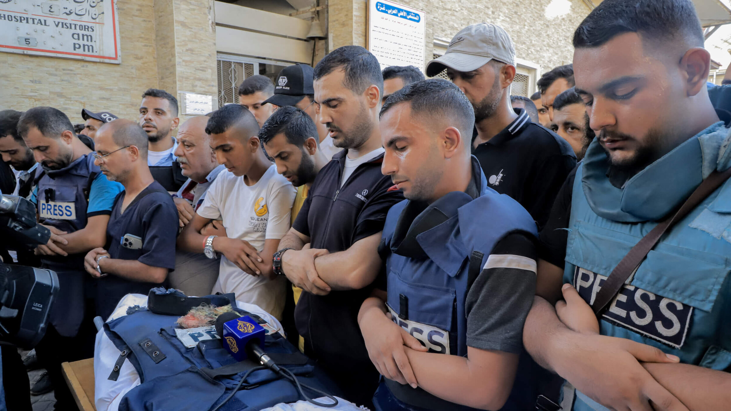 Mourners and colleagues surround the bodies of Al-Jazeera Arabic journalist Ismail al-Ghoul and cameraman Rami al-Refee, killed in an Israeli strike during their coverage of Gaza's Al-Shati refugee camp, on July 31. 