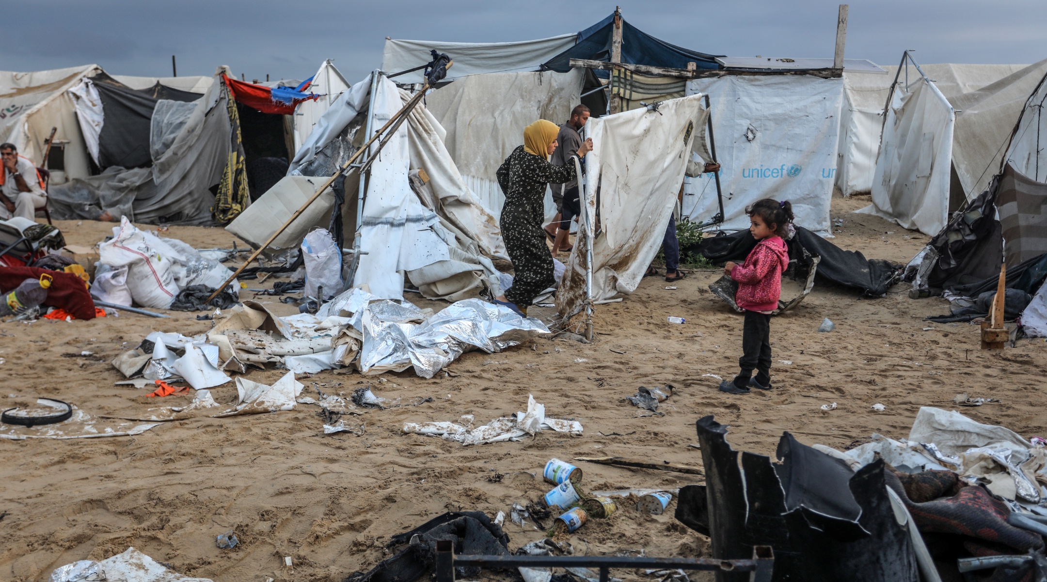 Displaced Palestinians inspect their tents, which were hit from an Israeli airstrike, in the Al-Mawasi area, Gaza Strip, Oct. 15, 2024. (Abed Rahim Khatib/Flash90)