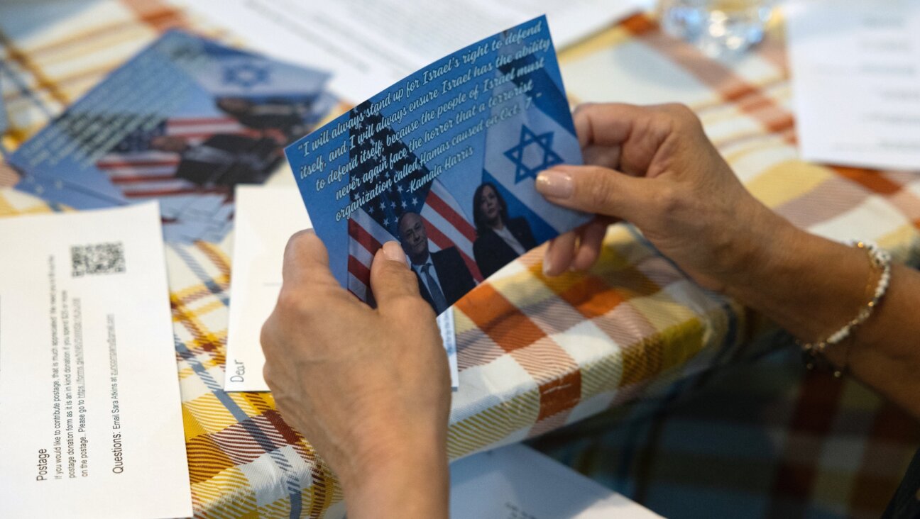 Ilene Miller holds a postcard that she has volunteered to send out to Jewish voters on behalf of the Democratic Committee of Lower Merion and Narberth in Wynnewood, Pennsylvania, Sept. 17, 2024. (Rachel Wisniewski/For the Washington Post/Getty Images)