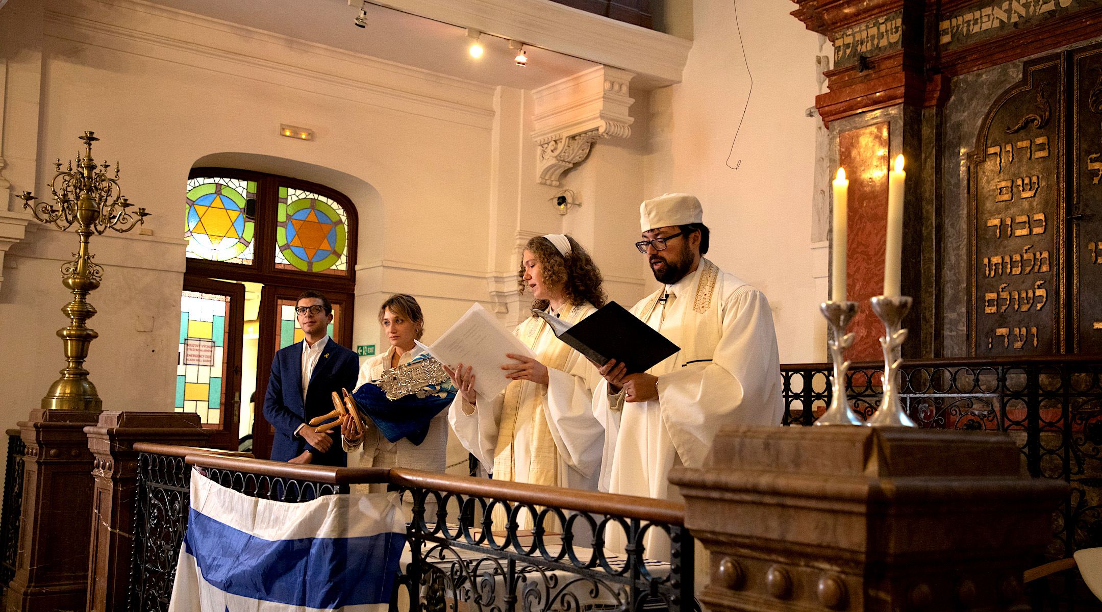 Ec Chajim Rabbi David Maxa and Student Rabbi Klára Kopytková lead the ancient prayer of Kol Nidrei during Yom Kippur services at the Klausen Synagogue in Prague, Oct. 11, 2024. Ec Chajim’s chair, Anna Noskova, is holding the Torah with World Union of Progressive Judaism Vice Chair Andrew Keene. (Dana Cabanova; Courtesy of the Jewish Museum in Prague)