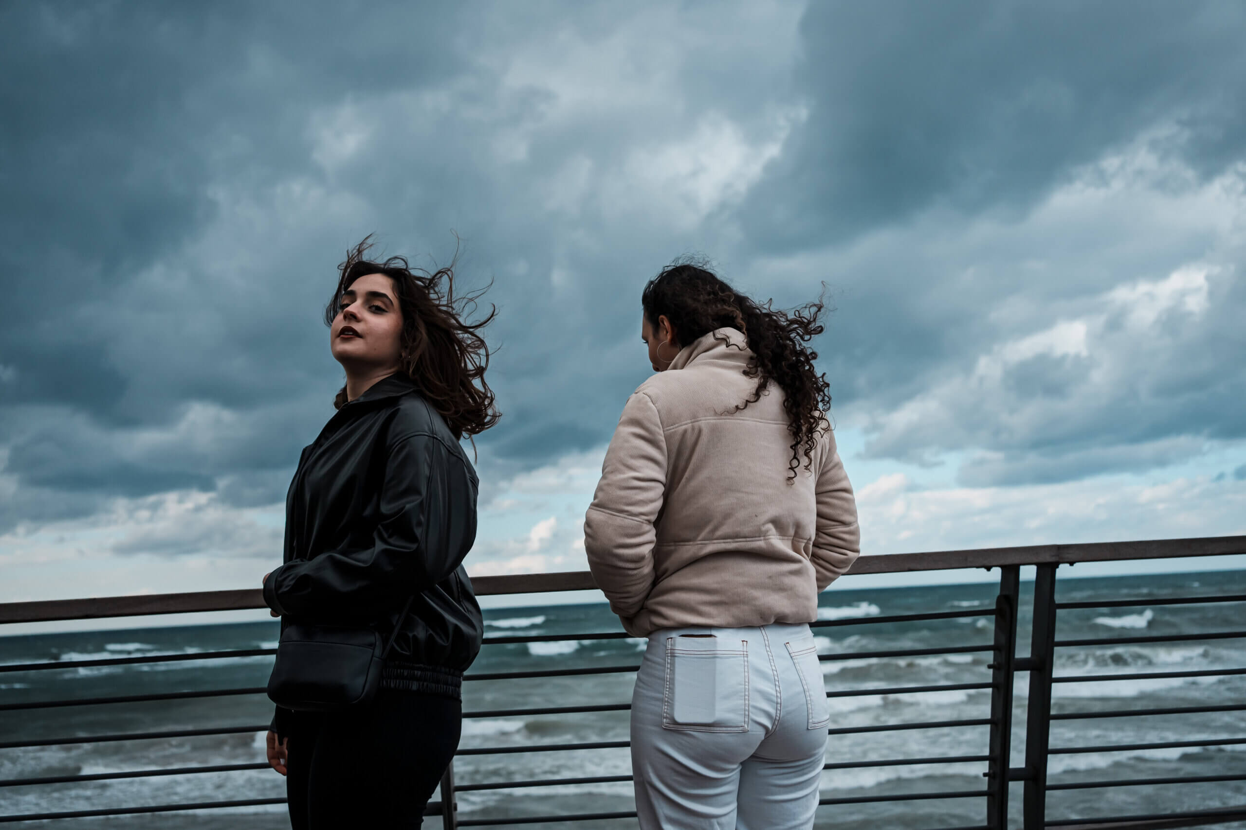 Angelina Shakkour, 16, left, and Adar Hirak Asaf, 16, right, visit the beach on a stormy day in Jaffa, Israel, Saturday, Jan. 27, 2024. The teens are 16-year-old girls both friends living in Israel, but unlike a lot of friends, the teens come from opposite sides of one of the world's most entrenched political conflicts. Angelina lives in Israel but is a Christian Palestinian. Adar is Jewish. For a long time, it didn't seem to matter that they didn't always see eye to eye on politics. Then came the brutal Hamas attack on southern Israel, and Israel's months-long retaliatory siege of the Gaza Strip. As the war deepened, they watched as other friends became more entrenched in their views, and as the gap between Palestinians and their Jewish Israeli neighbors dangerously widened. Both admit they sometimes hid their friendship from family members or others who might judge them. Thanks to the unique program that had brought them together in the first place, Angelina and Adar were unusually skilled at navigating differences of opinion. But as the war tore seemingly everything around them apart, a question hovered: Could their friendship survive intact?