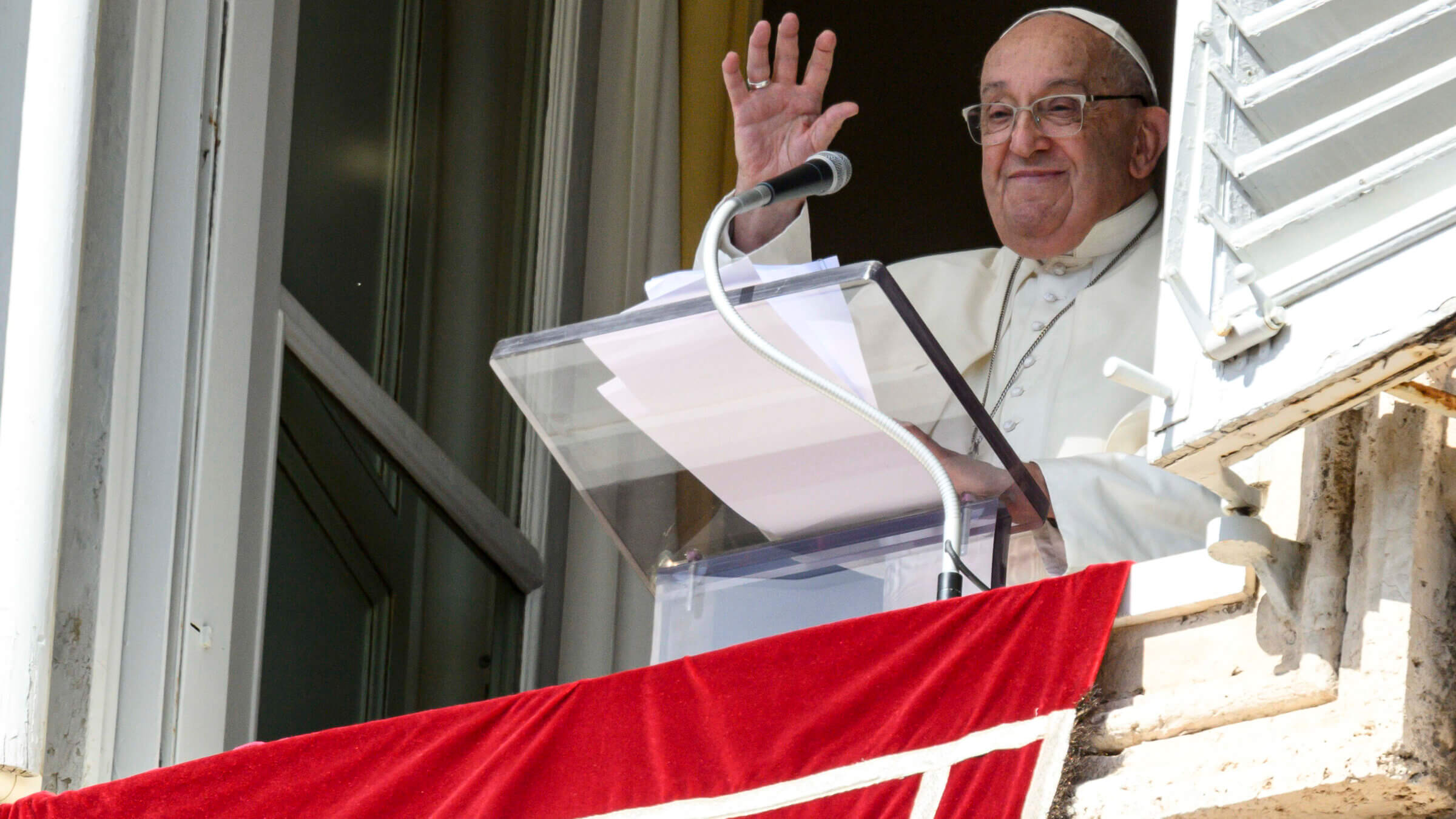 Pope Francis waves to the thousands of faithful gathered in St. Peter's Square, where he announced a fast for Oct. 7.