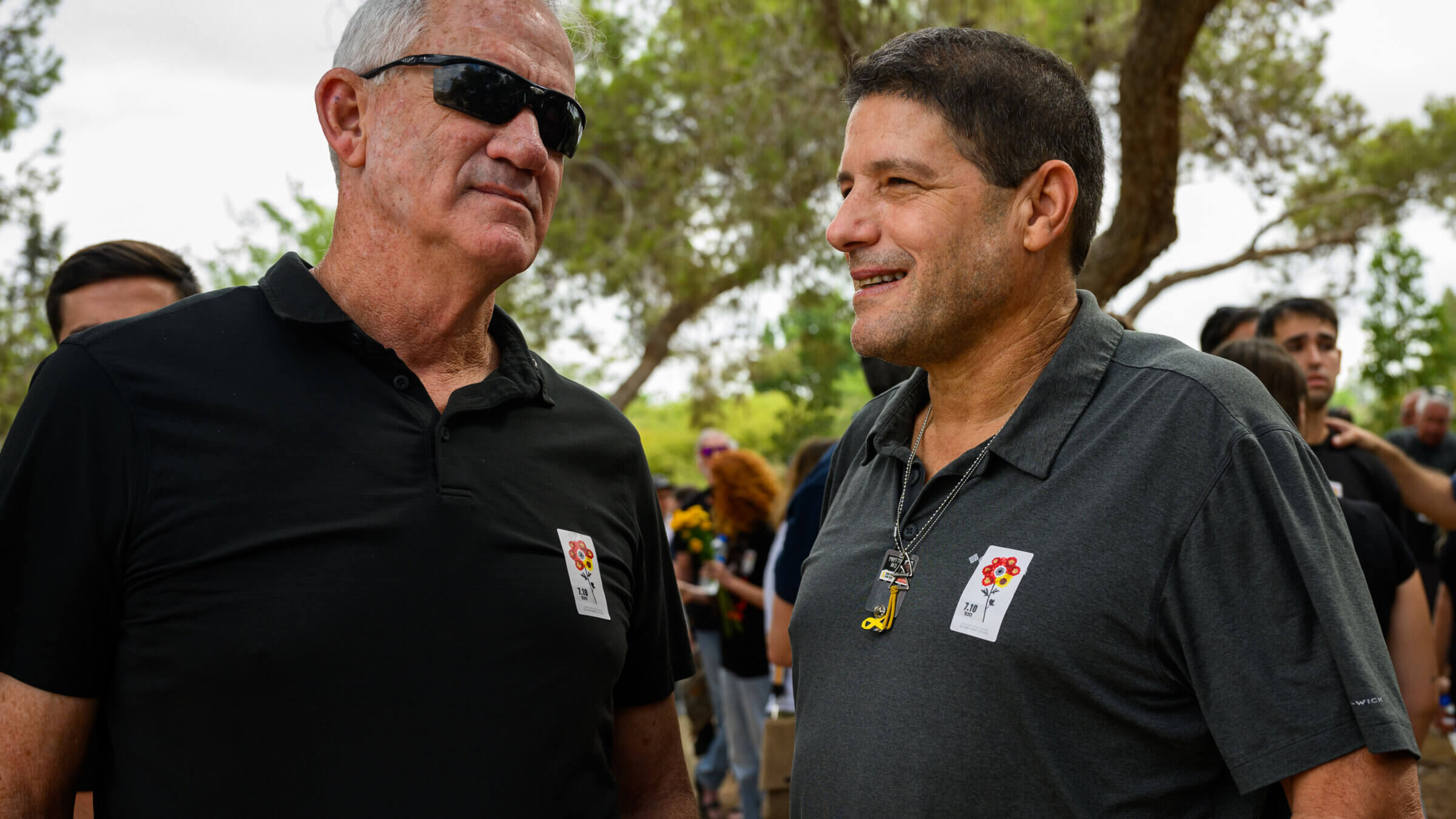  Benny Gantz (L) speaks to the son of hostage Oded Lifschitz (R) at the Kibbutz Nir Oz memorial service to mark the first anniversary since Hamas attacked one year ago on October 07, 2024 at Kibbutz Nir Oz, Israel. 