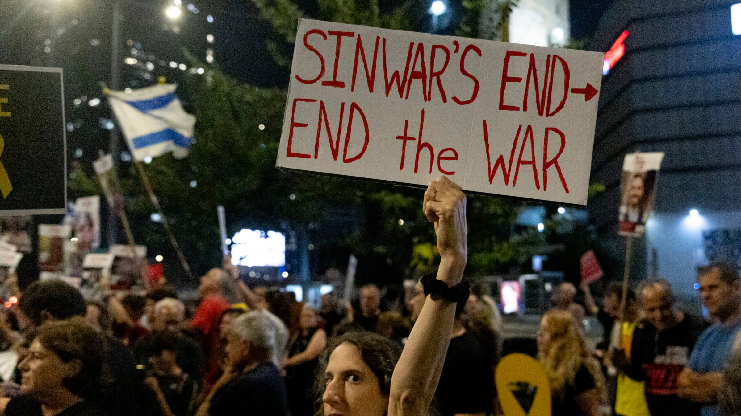  A protester holds a sign during a demonstration calling for an hostages deal in reaction to news of Yahya Sinwar's death on October 17, 2024 in Tel Aviv, Israel. 