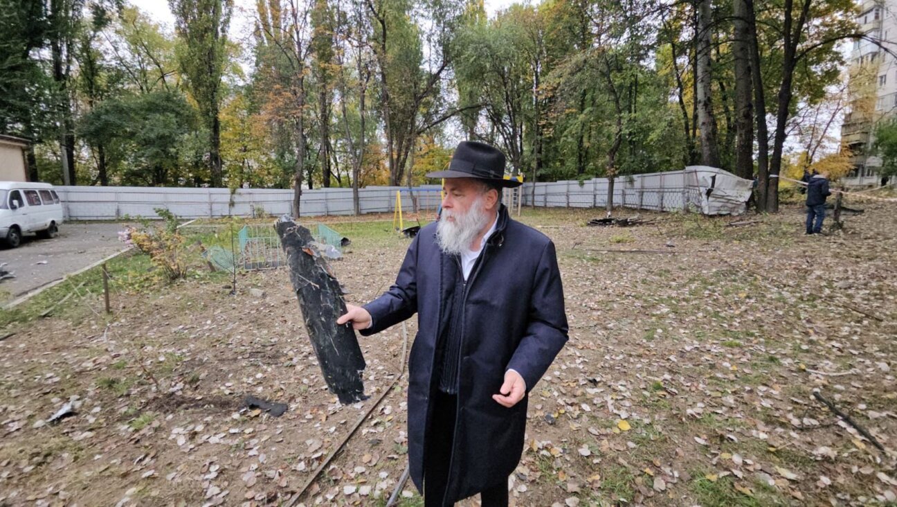 Rabbi Jonathan Markovitch holds a fragment of a Russian drone that damaged the Chabad-run Perlina school in Kyiv, Ukraine, Oct. 30, 2024. (Courtesy Kyiv Jewish Community)