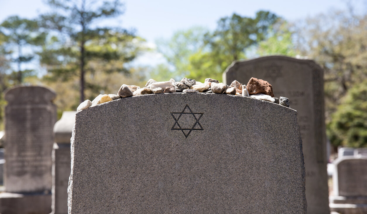 Jews have a custom to put rocks on top of gravestones.